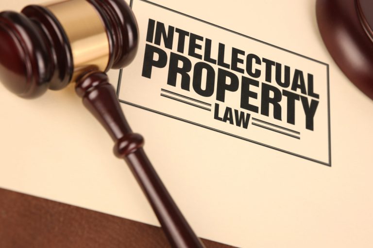 Intellectual property law written on a piece of paper with a gavel on it.